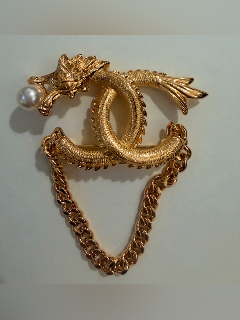 CHANEL Gold-Tone Dragon Brooch with Pearl Accent